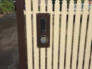 Cream steel picket fence with brown letterbox, posts and bottom rail - Geelong