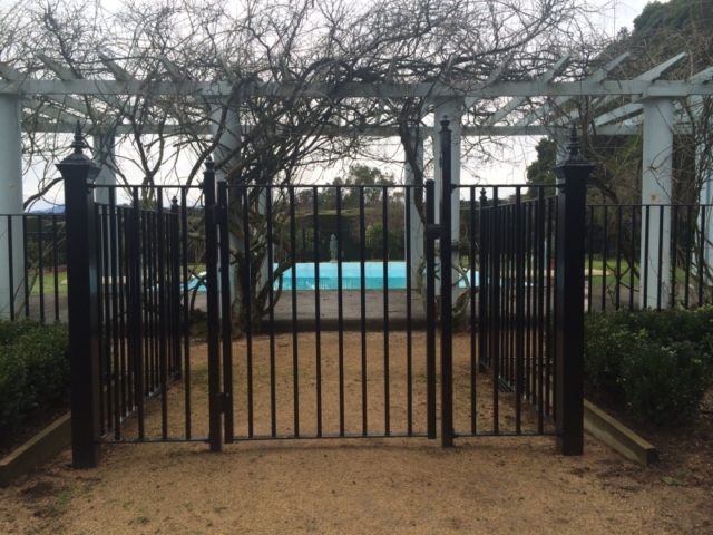 Black wrought iron pool fence and pool safety gate