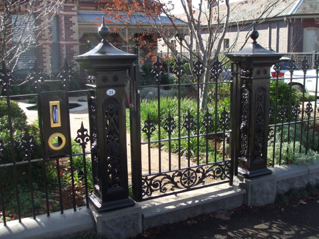 Black wrought iron fence, gate and letterbox
