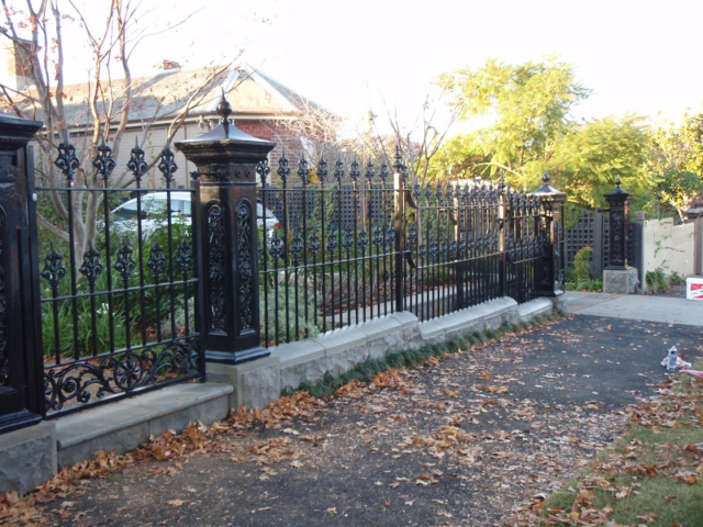 Black wrought iron fence and gate