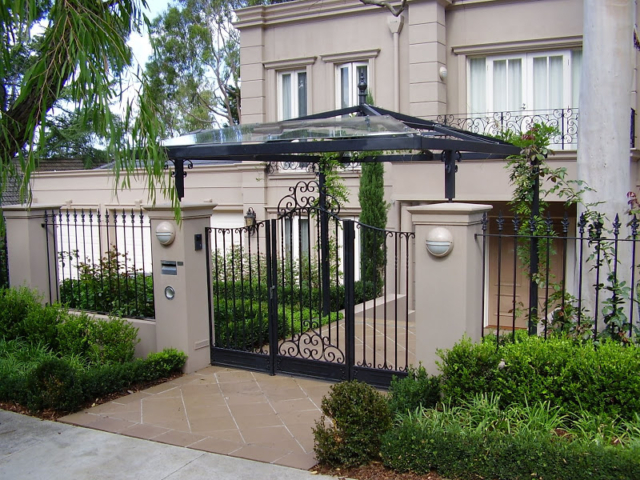 Black wrought iron fence and swing gate