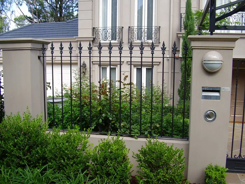 Black wrought iron fence and swing gate