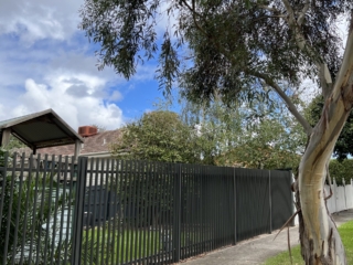 Steel blade fence with sliding gate steel-blade-fence-sliding-gate